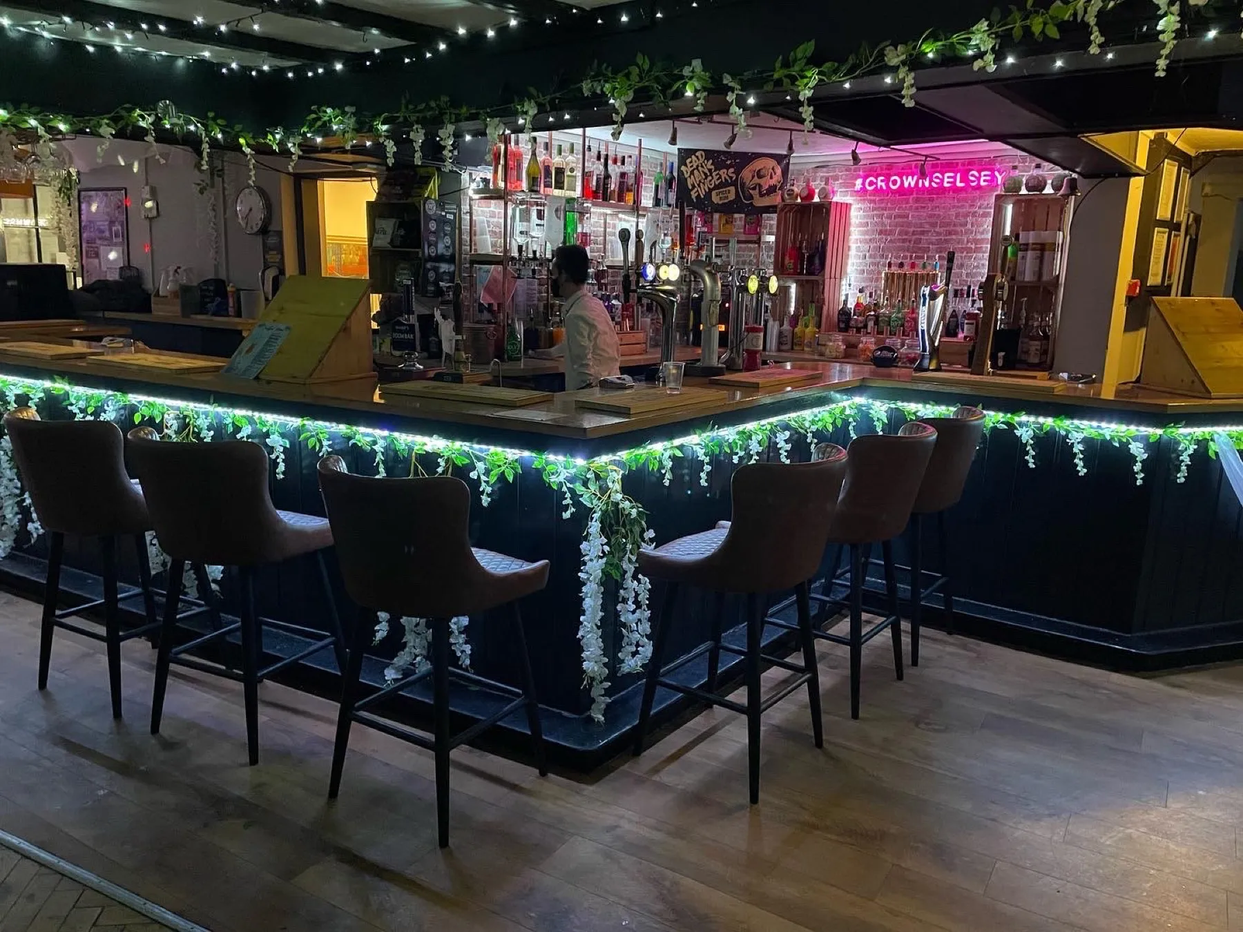 The bar at The Crown Inn Selsey, dressed with flowers and fairy lights