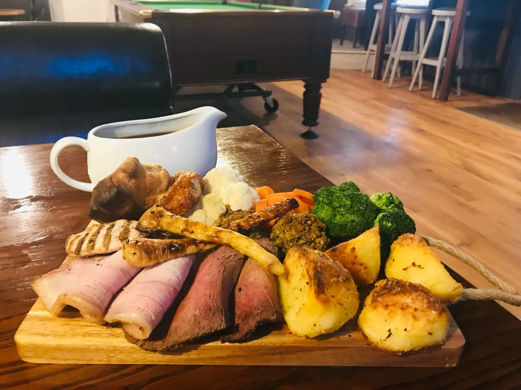 A sharing board of roast meats, roast potatoes, seasonal vegetables and gravy at The Crown Inn Selsey